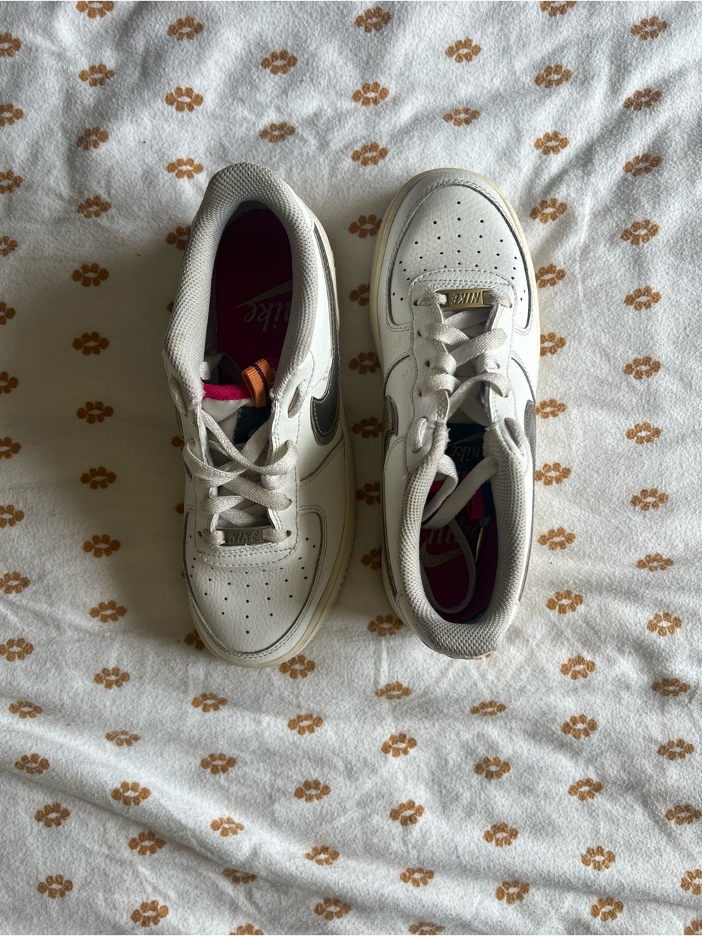 Nike White Low-Top Sneakers with Black Swoosh and Pink Insole